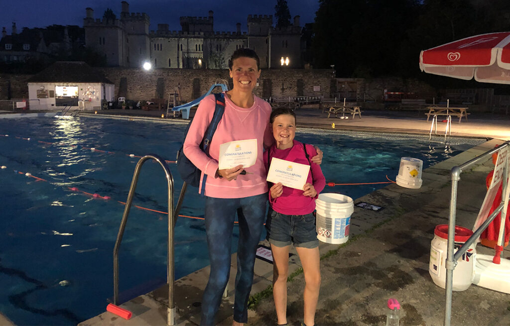 Adult and Child at night next to pool