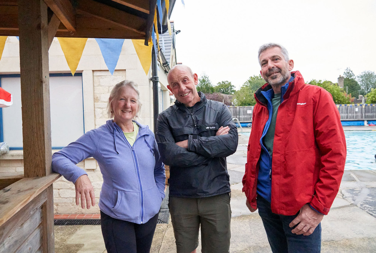Three members stood by the pool
