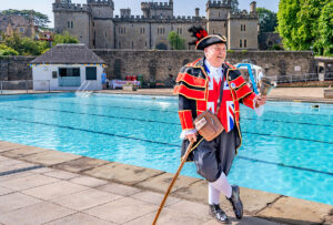 Town Crier next to pool