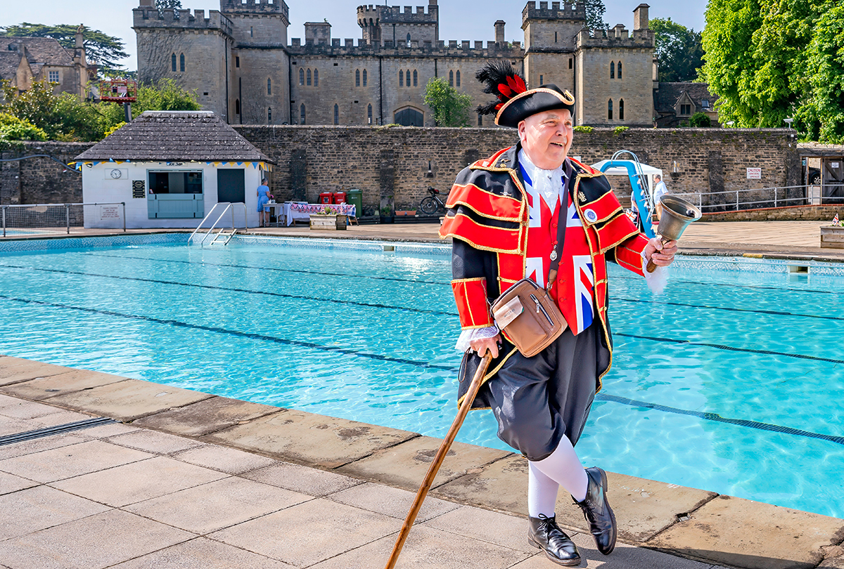 Town Crier next to pool