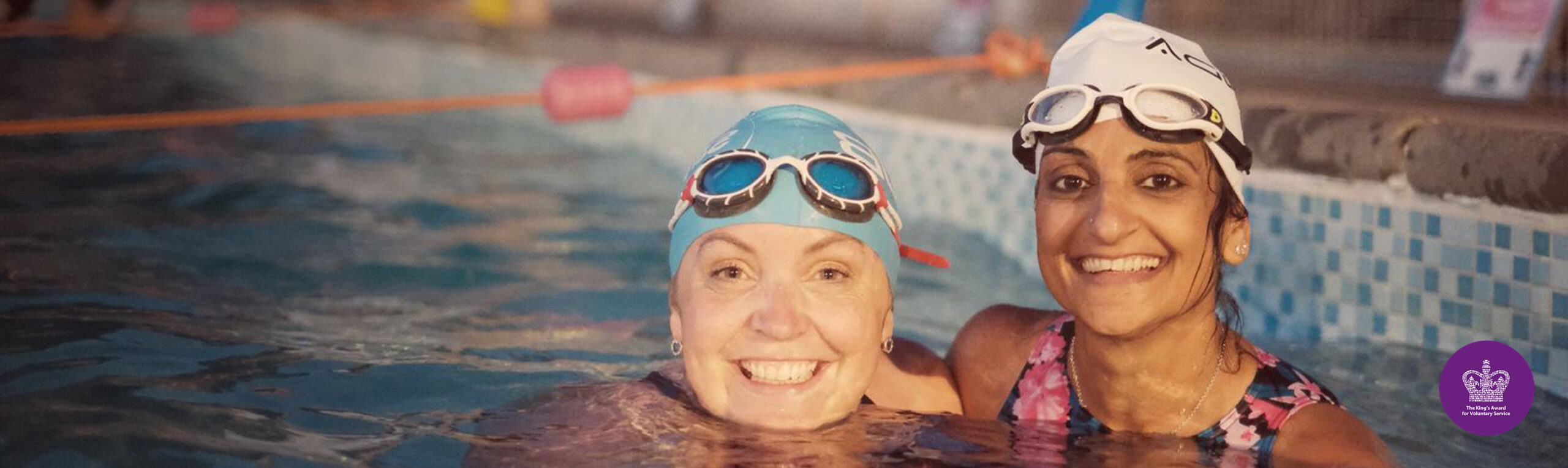 Two female swimmers at night