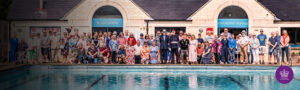 :arge group of people in front of the pool