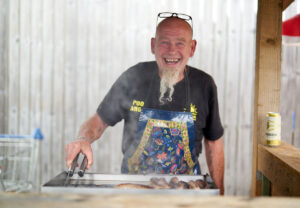 A man cooking at the BBQ