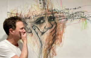 A man looking at artwork