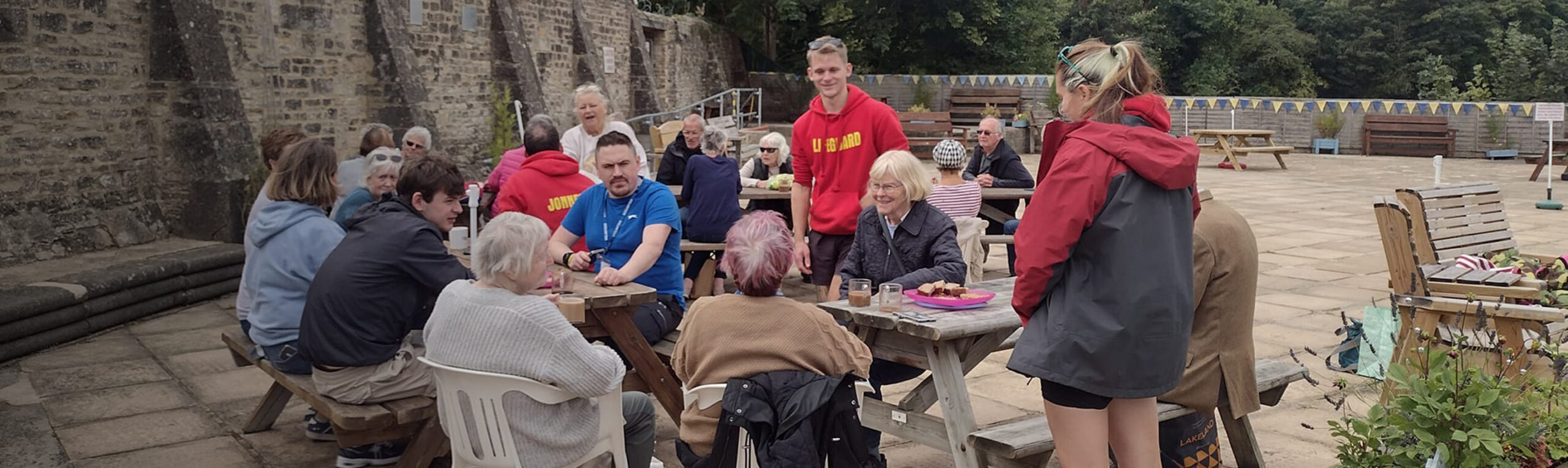 Group of people socialising around poolside