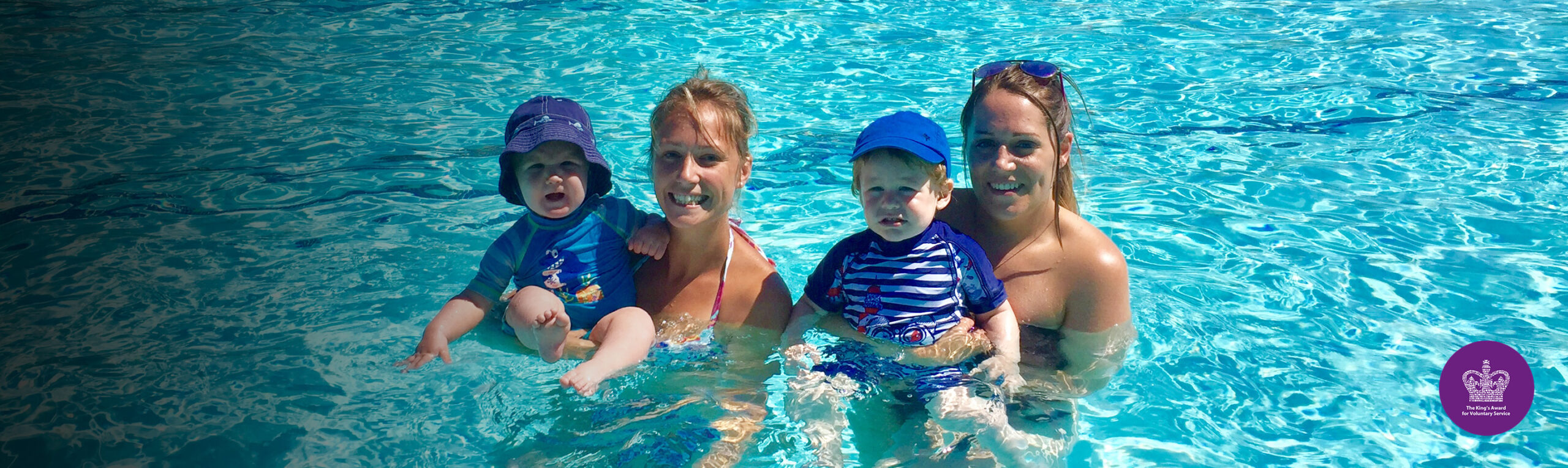 Two ladies and children in pool