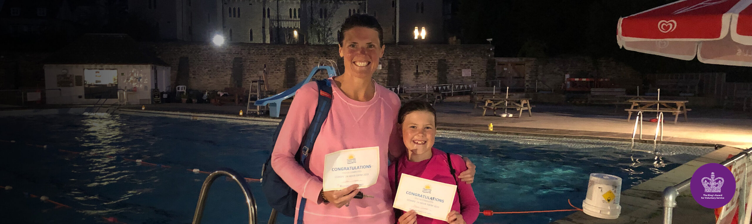 Mother and daughter at night poolside